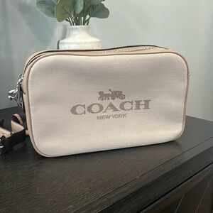 New without tags COACH crossbody double zipper bag in beige/cream color.